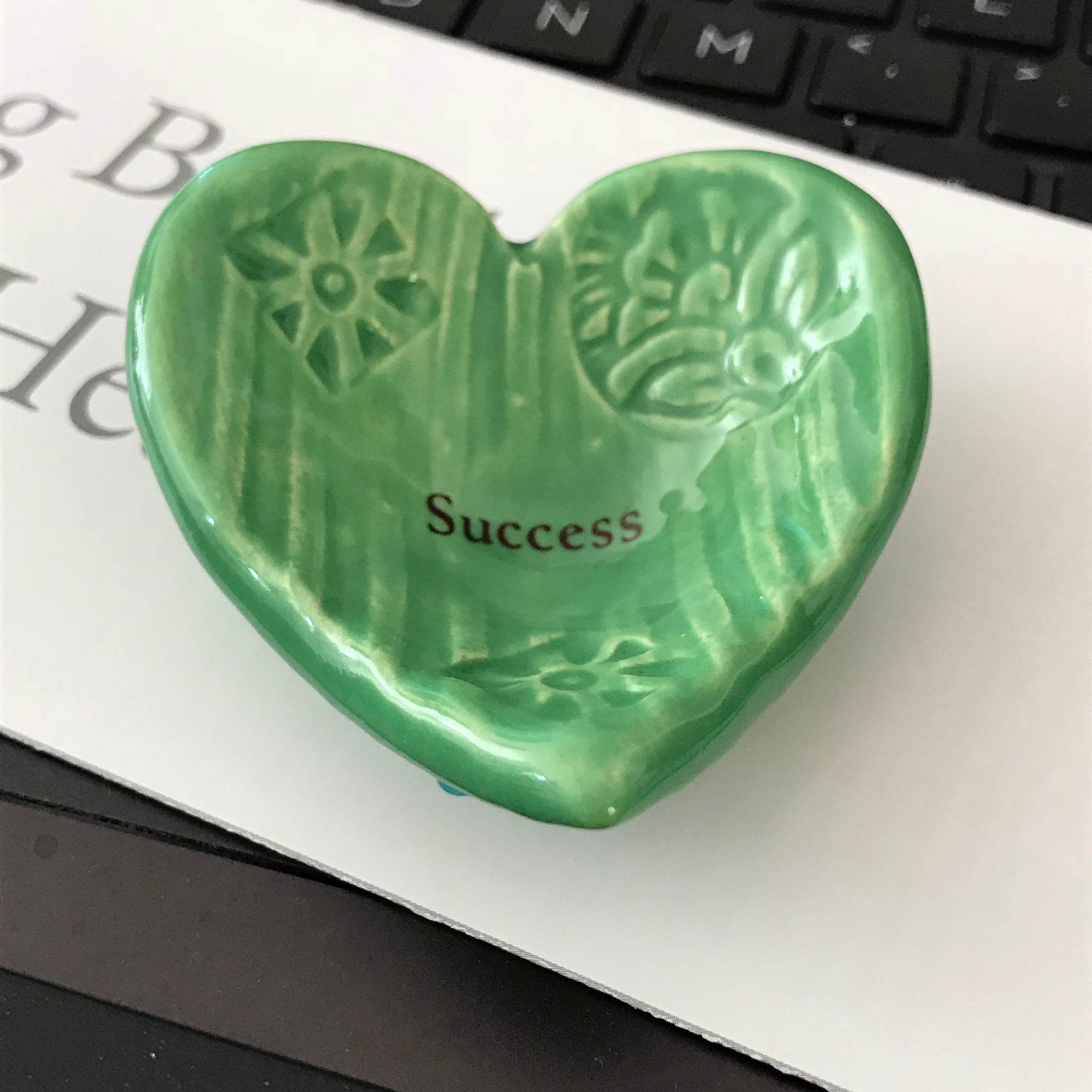 Giving Heart imprinted with the word "Success".   A gift for family or friends that shows your support.  Shown in emerald green glaze.