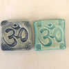 Magnets with &quot;Om&quot; symbol.  Om is often chanted at the beginning and end of a yoga session.