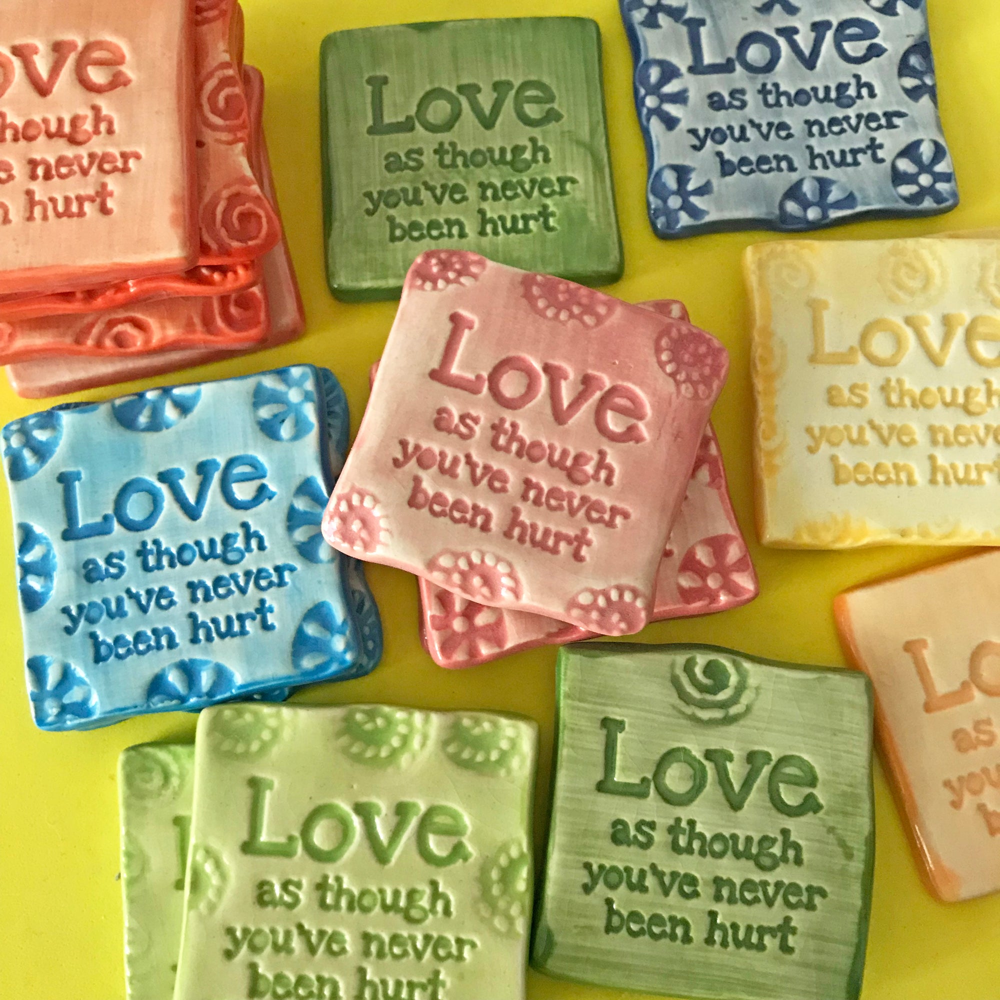 Hand made magnet with the phrase "Love as though you've never been hurt".  