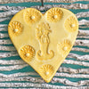 Bright sunny yellow glaze on our Mermaid Heart Ornament.  Handmade and each varies.