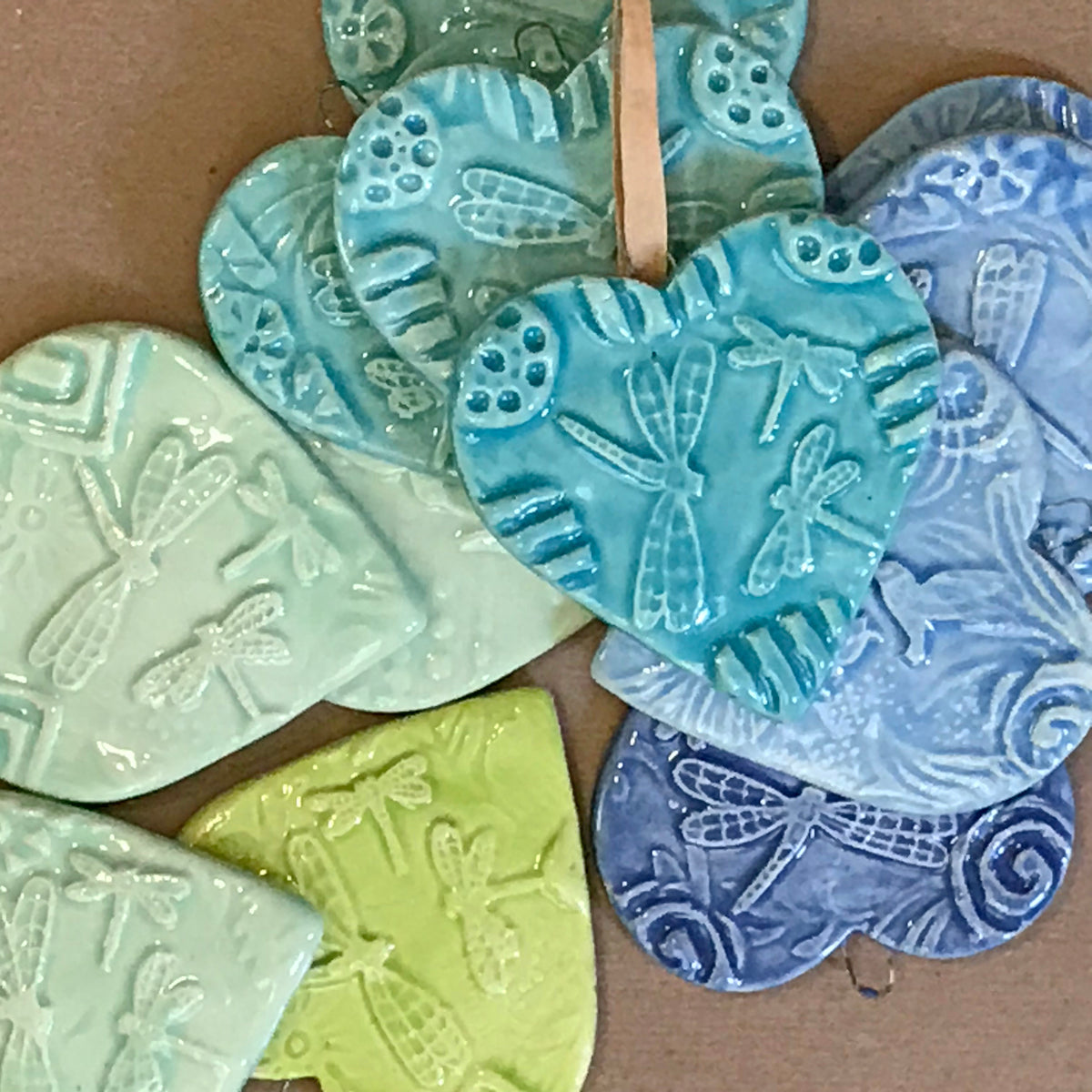 Picture showing the range of blues and greens available in our Dragonfly Heart Ornaments. 