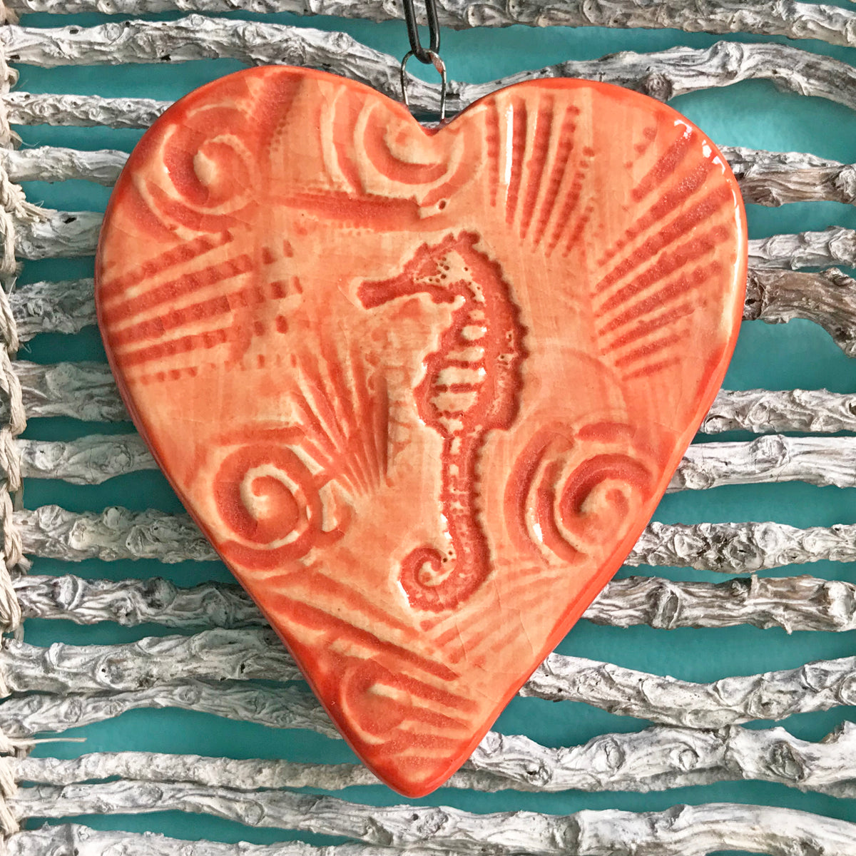 Sea Horse Ornament hand crafted by artisans of Oerth Studio, Alexandria Virginia.  Glazed in bright coral.