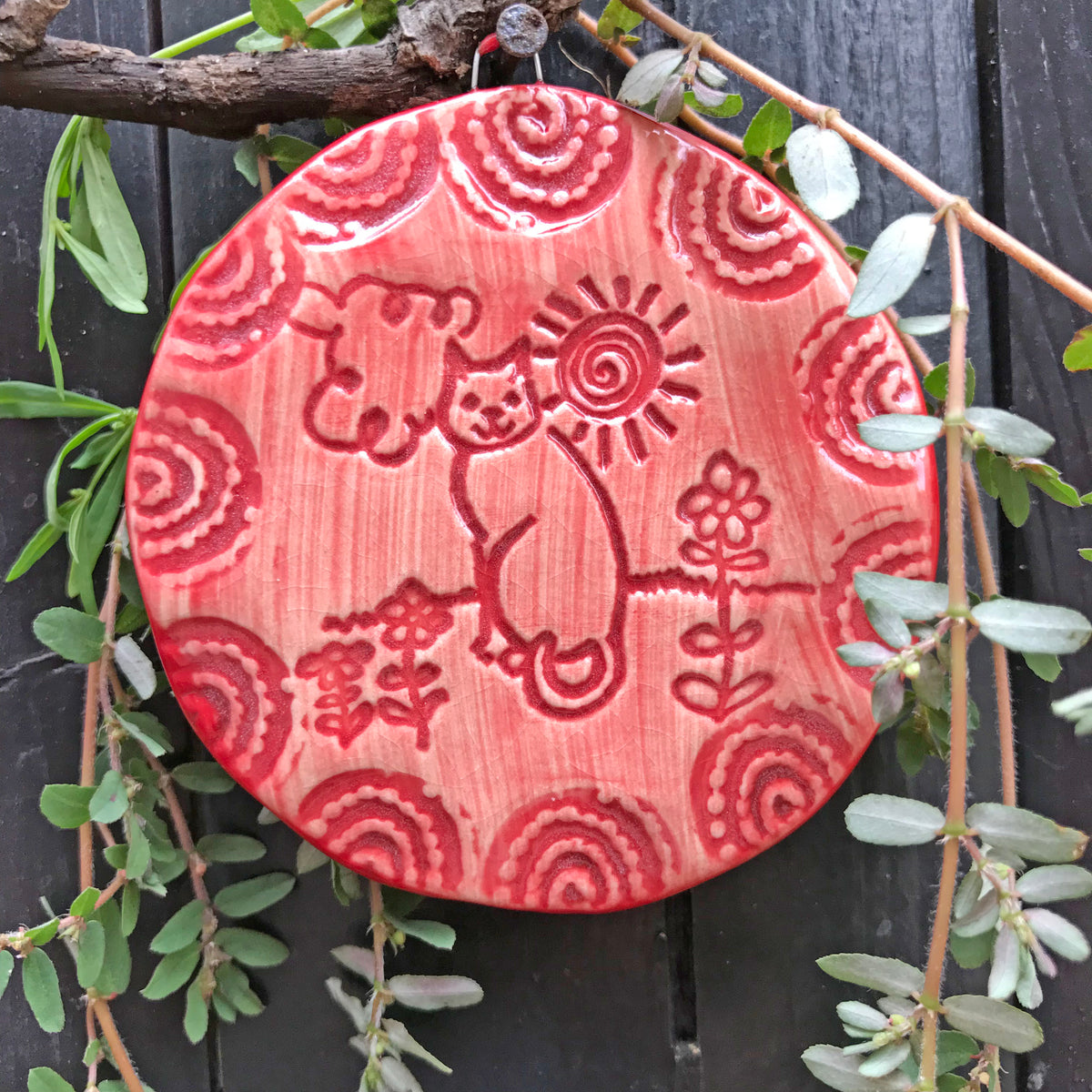 A christmas ornament for cat lovers, the Cat in the Sun design is glazed in Christmas Red.  It is a whimsical design that many people display year round.  