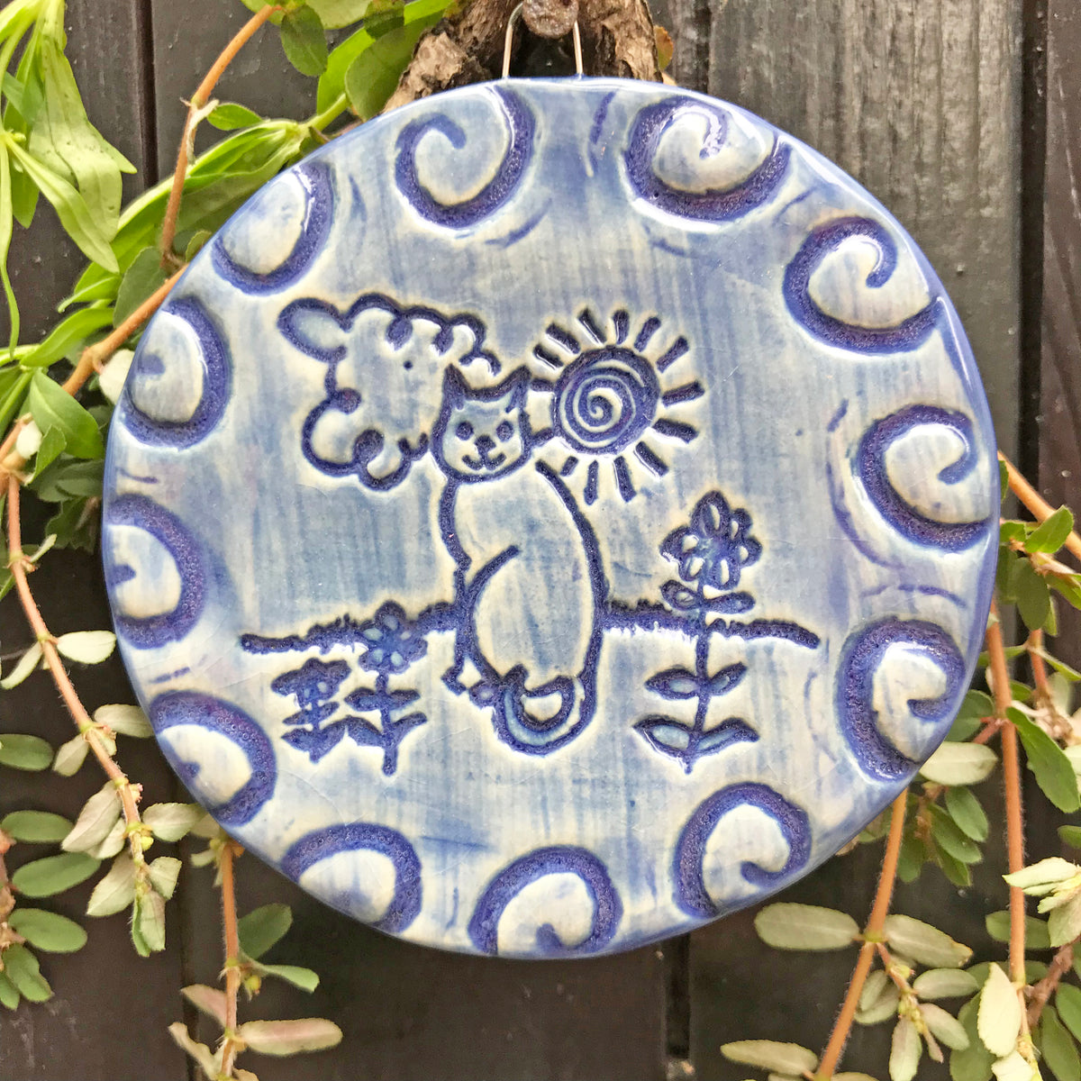 Handmade cat ornament glazed in dark blue.  The design is called &quot;Cat in the Sun&quot; and it is an original by Lorraine Oerth.
