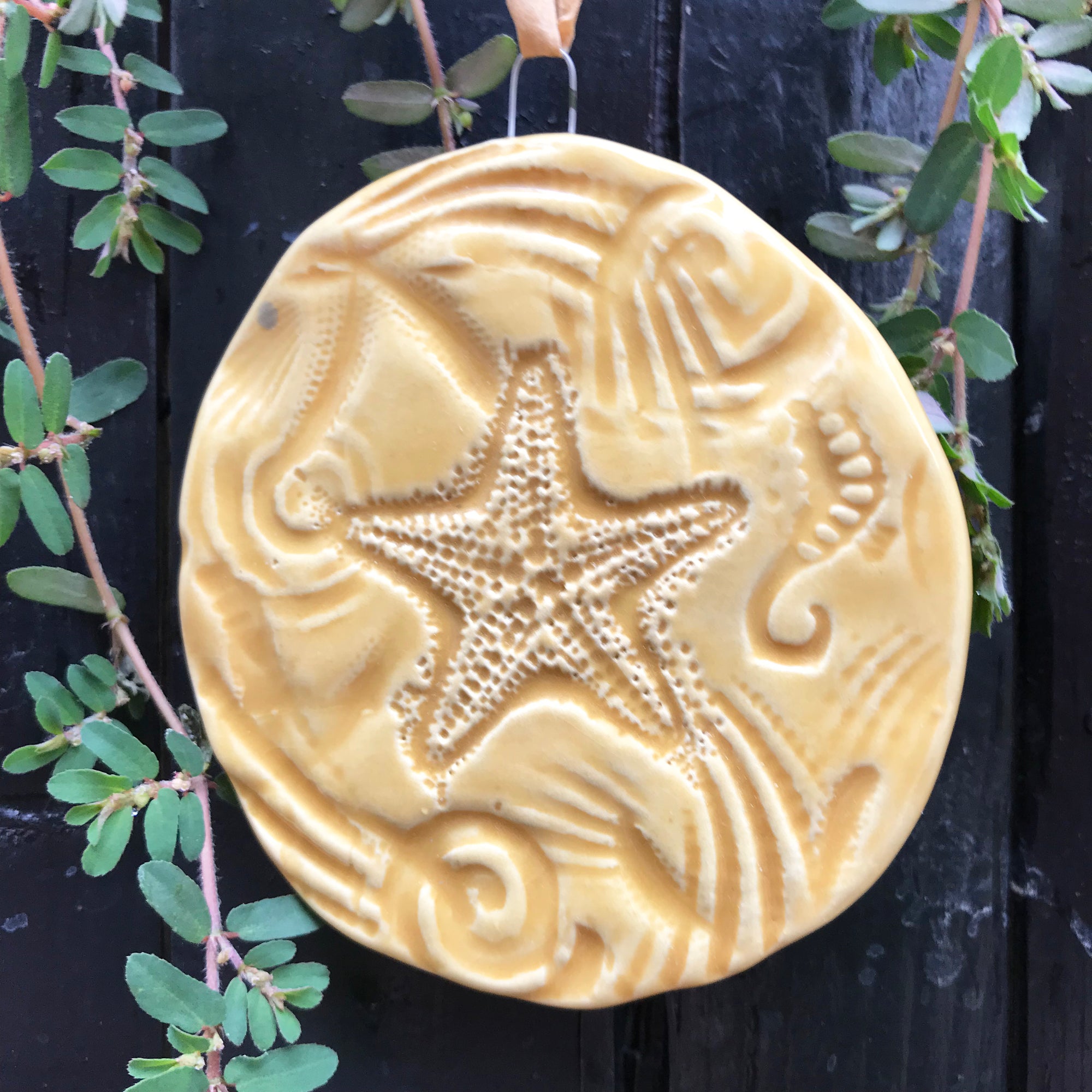 Starfish Ornament in sandy color glaze.  Real shells and seal life are pressed into the clay.  It's like a walk on the beach.