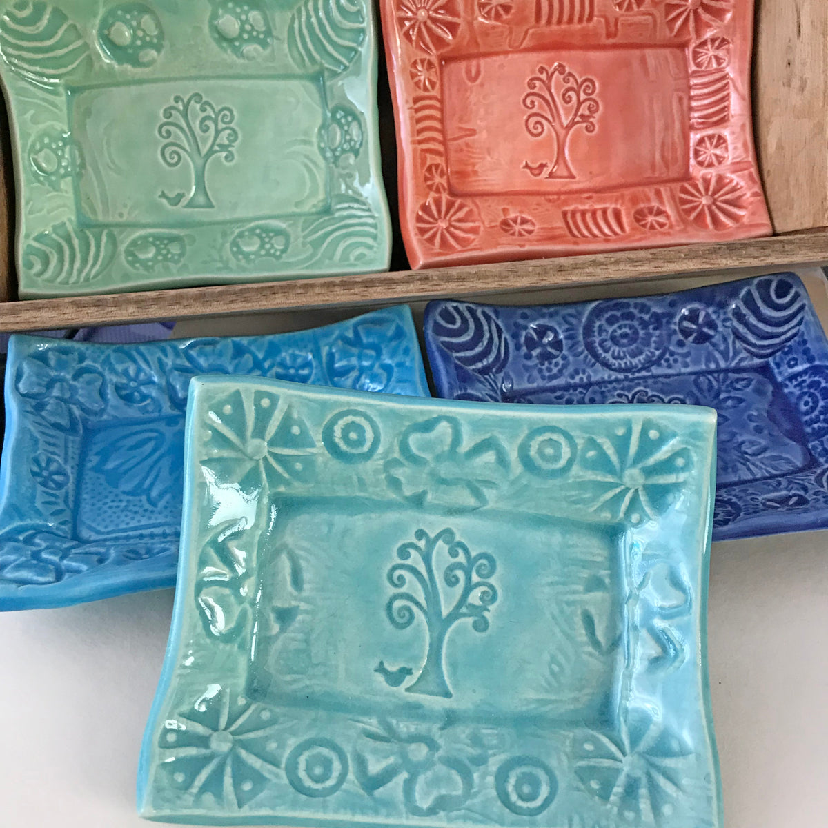 Tree of Life Design hand impressed into clay, then glazed with bright colors to enhance the texture.  Often used as a small tray for appetizers.rs