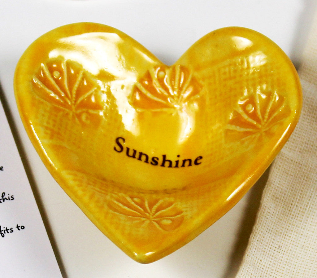 Giving Heart with the word Sunshine glazed in yellow.  Crafted by hand.  