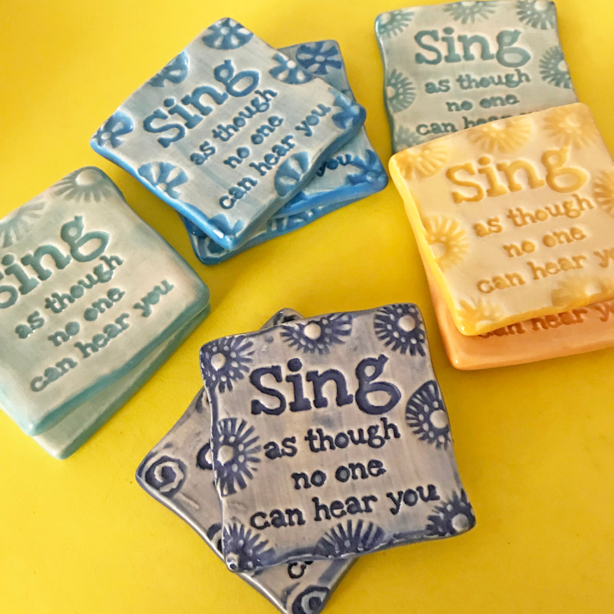 Ceramic magnet with the uplifting phrase "Sing as though no one can hear you".