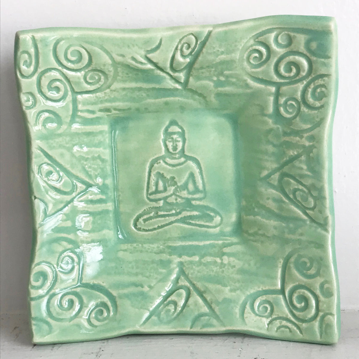 Pottery Buddha Dish glazed in celadon green.