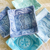 A mermaid, star fish, sea horse, ocean, and sand dollar are crafted in fine detail on handmade pottery tiny dishes. 